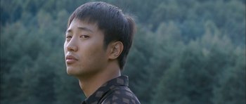 Movie still from “Mother” (2009), directed by Bong Joon Ho – A person wearing a black shirt; Close Up shot, Over the shoulder angle