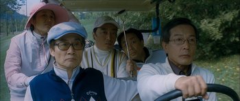 Movie still from “Mother” (2009), directed by Bong Joon Ho – A group of men riding in the back of a vehicle; Medium shot, Low angle
