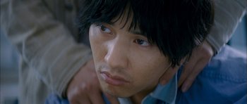Movie still from “Mother” (2009), directed by Bong Joon Ho – A person wearing a blue shirt; Close Up shot, High angle