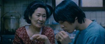 Movie still from “Mother” (2009), directed by Bong Joon Ho – A woman and a boy are talking to each other; Close Up shot, Over the shoulder angle