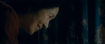 Movie still from “Mother” (2009), directed by Bong Joon Ho – A woman's face in the dark; Close Up shot, Over the shoulder angle