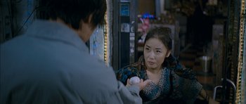 Movie still from “Mother” (2009), directed by Bong Joon Ho – A man and a woman are looking at each other; Close Up shot, Over the shoulder angle