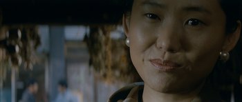 Movie still from “Mother” (2009), directed by Bong Joon Ho – A woman's face with a smile; Close Up shot, Over the shoulder angle