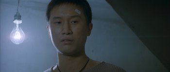 Movie still from “Mother” (2009), directed by Bong Joon Ho – A man with a bandage on his forehead; Close Up shot, Low angle
