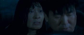 Movie still from “Mother” (2009), directed by Bong Joon Ho – A woman's face in the dark; Close Up shot, Over the shoulder angle