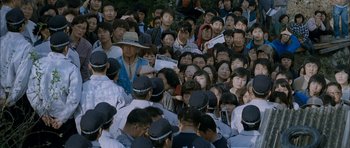 Movie still from “Mother” (2009), directed by Bong Joon Ho – A large group of people gathered together in a crowd; Wide shot, High angle