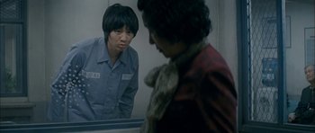 Movie still from “Mother” (2009), directed by Bong Joon Ho – A woman looking in the mirror while another woman looks on; Medium shot, Over the shoulder angle