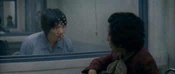Movie still from “Mother” (2009), directed by Bong Joon Ho – A man and a woman looking at each other in front of a bathroom mirror; Close Up shot, Over the shoulder angle