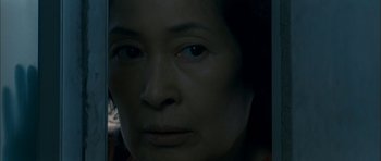 Movie still from “Mother” (2009), directed by Bong Joon Ho – A woman's face in the dark; Extreme Close Up shot, High angle
