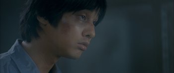 Movie still from “Mother” (2009), directed by Bong Joon Ho – A person looking to his left; Close Up shot, Low angle