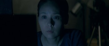 Movie still from “Mother” (2009), directed by Bong Joon Ho – A person looking at the camera; Close Up shot, High angle