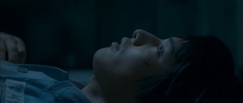 Movie still from “Mother” (2009), directed by Bong Joon Ho – A person laying down with their eyes closed; Close Up shot, Overhead angle
