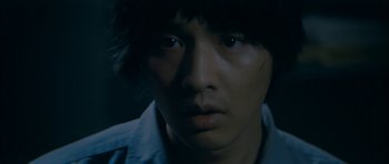 Movie still from “Mother” (2009), directed by Bong Joon Ho – A person's face in the dark; Close Up shot, High angle