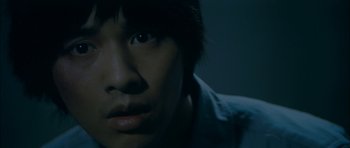 Movie still from “Mother” (2009), directed by Bong Joon Ho – A person's face in the dark; Close Up shot, Overhead angle