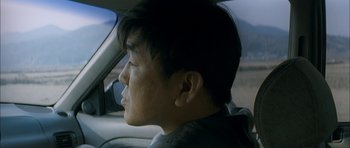 Movie still from “Mother” (2009), directed by Bong Joon Ho – A man sitting in the driver's seat of a car; Close Up shot, Low angle