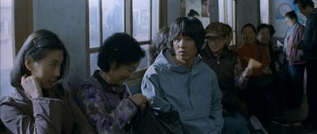 Movie still from “Mother” (2009), directed by Bong Joon Ho – A man sitting on top of a bus next to a woman; Medium shot, Over the shoulder angle