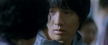 Movie still from “Mother” (2009), directed by Bong Joon Ho – A person with long black hair; Extreme Close Up shot, Over the shoulder angle