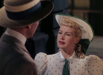 Movie still from “Mother Wore Tights” (1947), directed by Walter Lang – A man and a woman wearing hats and a tie; Close Up shot, Over the shoulder angle