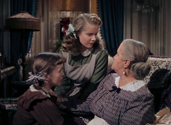 Movie still from “Mother Wore Tights” (1947), directed by Walter Lang – Two women and a little girl sitting on a couch; Medium shot, High angle