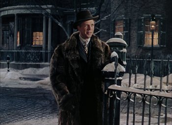 Movie still from “Mother Wore Tights” (1947), directed by Walter Lang – A man in a fur coat and hat standing next to a fire hydrant; Medium shot, Low angle
