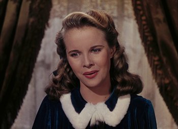 Movie still from “Mother Wore Tights” (1947), directed by Walter Lang – A young woman with long blonde hair wearing a blue dress; Close Up shot, Over the shoulder angle