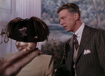 Movie still from “Mother Wore Tights” (1947), directed by Walter Lang – A man and a woman in a suit and tie talking to each other; Close Up shot, Over the shoulder angle