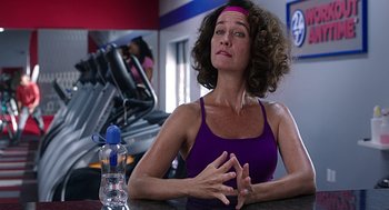 Movie still from “Mother's Day” (2016), directed by Garry Marshall – A woman sitting at a table in front of a water bottle; Close Up shot, Over the shoulder angle