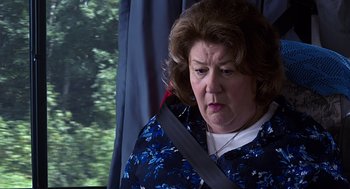 Movie still from “Mother's Day” (2016), directed by Garry Marshall – An older woman wearing a blue floral shirt; Close Up shot, Over the shoulder angle