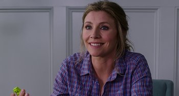 Movie still from “Mother's Day” (2016), directed by Garry Marshall – A person wearing a plaid shirt smiling; Close Up shot, Over the shoulder angle