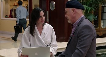 Movie still from “Mother's Day” (2016), directed by Garry Marshall – A man and a woman talking to each other while looking at a laptop computer; Medium shot, Over the shoulder angle