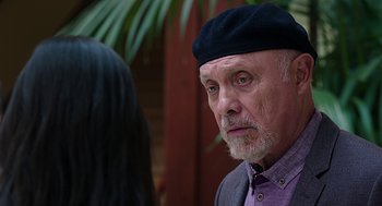 Movie still from “Mother's Day” (2016), directed by Garry Marshall – An older man wearing a black hat looking at a woman; Close Up shot, Over the shoulder angle