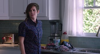 Movie still from “Mother's Day” (2016), directed by Garry Marshall – A woman standing in a kitchen next to a blender; Medium shot, Over the shoulder angle