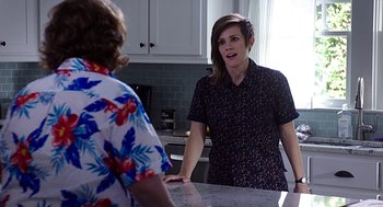 Movie still from “Mother's Day” (2016), directed by Garry Marshall – Two women are standing in a kitchen talking; Medium shot, Over the shoulder angle