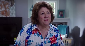 Movie still from “Mother's Day” (2016), directed by Garry Marshall – An older woman wearing a floral shirt in front of a window; Close Up shot, Over the shoulder angle