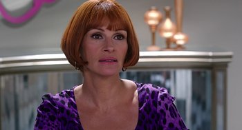 Movie still from “Mother's Day” (2016), directed by Garry Marshall – A person with short hair wearing a dress; Close Up shot, Over the shoulder angle