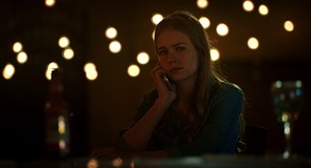 Movie still from “Mother's Day” (2016), directed by Garry Marshall – A woman sitting at a table talking on a cell phone; Close Up shot, Over the shoulder angle