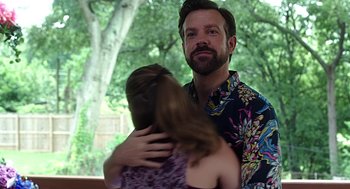 Movie still from “Mother's Day” (2016), directed by Garry Marshall – A man and a woman hugging in front of a tree; Medium shot, Over the shoulder angle