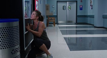 Movie still from “Mother's Day” (2016), directed by Garry Marshall – A woman kneeling on the ground in a room; Medium shot, Over the shoulder angle