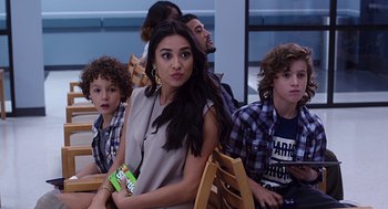 Movie still from “Mother's Day” (2016), directed by Garry Marshall – A group of young people sitting in a room together; Medium shot, Over the shoulder angle