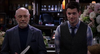 Movie still from “Mother's Day” (2016), directed by Garry Marshall – A man and a man standing next to each other in a bar; Medium shot, Over the shoulder angle