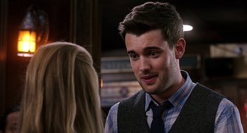 Movie still from “Mother's Day” (2016), directed by Garry Marshall – A man in a vest and tie talking to a woman in front of him; Close Up shot, Over the shoulder angle