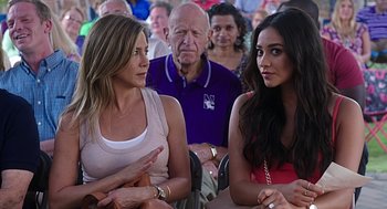 Movie still from “Mother's Day” (2016), directed by Garry Marshall – Two women sitting next to each other in a crowd of people; Close Up shot, Over the shoulder angle