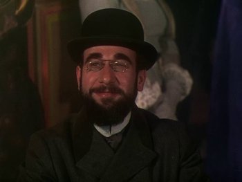 Movie still from “Moulin Rouge” (1952), directed by John Huston – A man with a beard wearing glasses and a hat; Close Up shot, Low angle