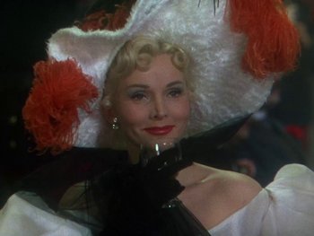 Movie still from “Moulin Rouge” (1952), directed by John Huston – A person holding a glass of wine; Close Up shot, Low angle