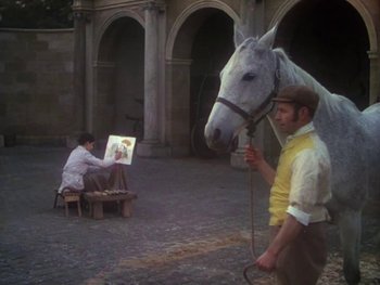 Movie still from “Moulin Rouge” (1952), directed by John Huston – A man standing next to a white horse near an easel; Wide shot, Low angle