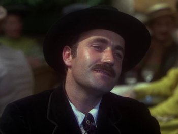 Movie still from “Moulin Rouge” (1952), directed by John Huston – A man with a mustache wearing a black hat; Close Up shot, Low angle