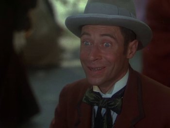 Movie still from “Moulin Rouge” (1952), directed by John Huston – A person wearing a suit and a hat; Close Up shot, Low angle