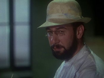 Movie still from “Moulin Rouge” (1952), directed by John Huston – A man with a beard and a hat and eyeglasses; Close Up shot, Low angle