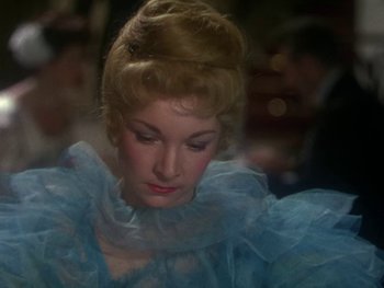 Movie still from “Moulin Rouge” (1952), directed by John Huston – A person wearing a blue dress; Close Up shot, High angle