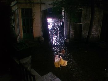 Movie still from “Moulin Rouge” (1952), directed by John Huston – A person is walking down the street at night; Extreme Wide shot, High angle